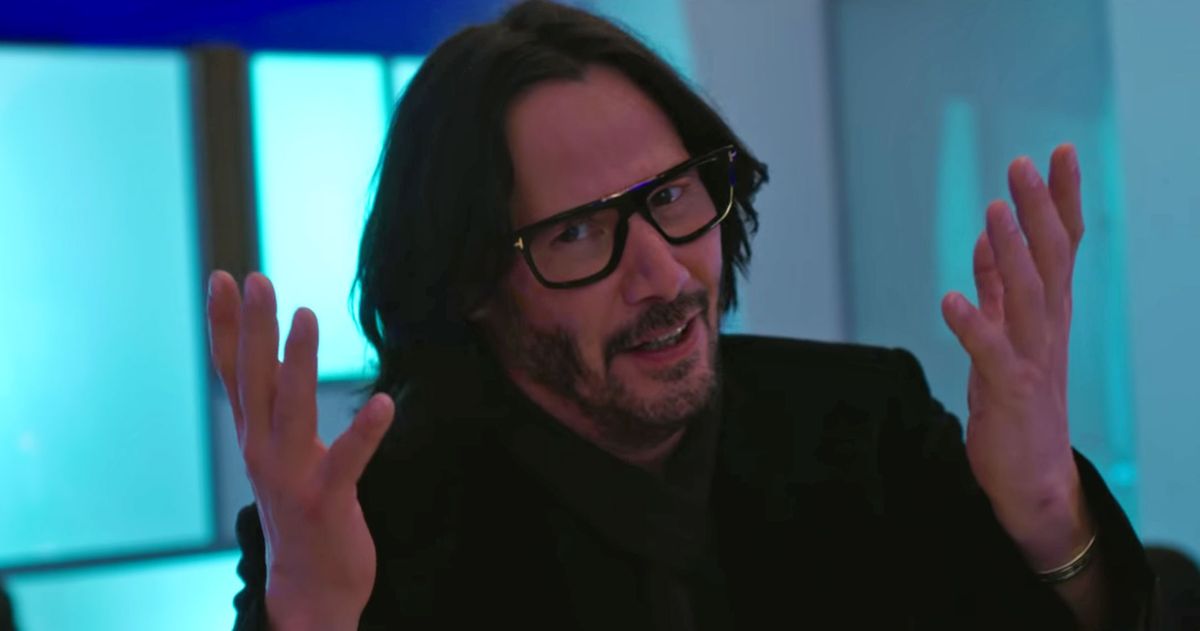 Keanu holding his hands up